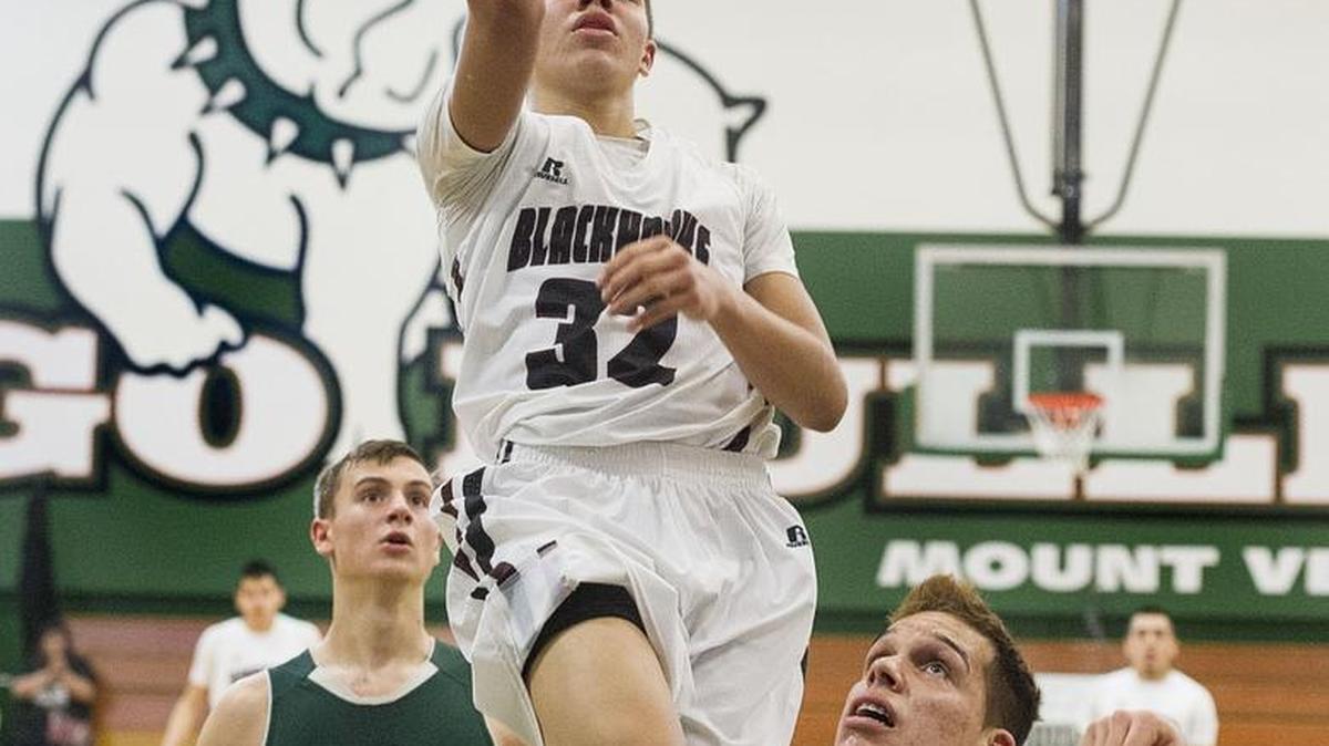 Lummi’s Trazil Lane (32) drives to the basket against Mt. Rainer during a regional tournament game at Mount Vernon High School on Feb. 28, 2015. State basketball coaches named Lane the top player in Class 1B this season.