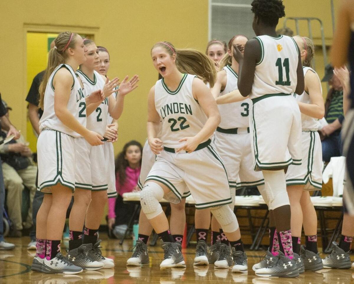 The Lynden girls’ basketball teams cheers during pregame introductions against Lynden Christian on Thursday, Jan. 19, at Lynden High School in Lynden. The game was the first of a doubleheader on Coaches vs. Cancer night.