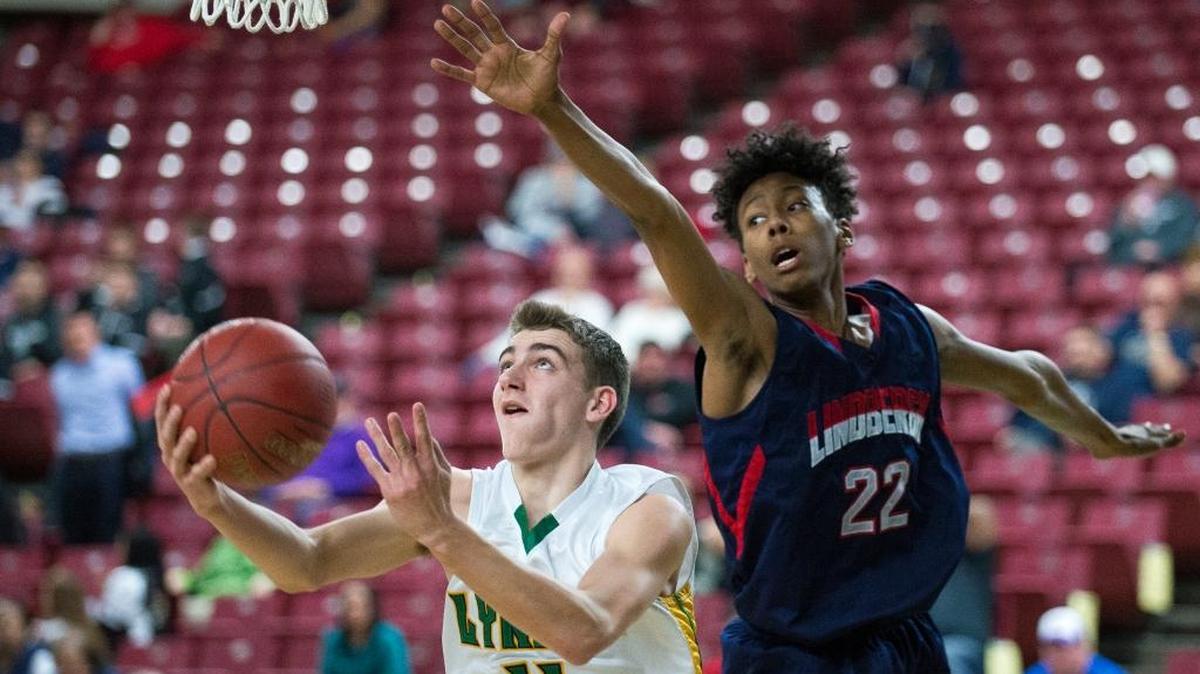 Lynden’s Clayton Whitman shoots around the outstretched arm of Lindbergh’s Jalen Green on opening day of the Class 2A Hardwood Classic on Wednesday, March 1, at the Yakima Valley SunDome in Yakima. Lynden defeated Lindbergh, 57-43, and will meet Anacortes in the quarterfinals.