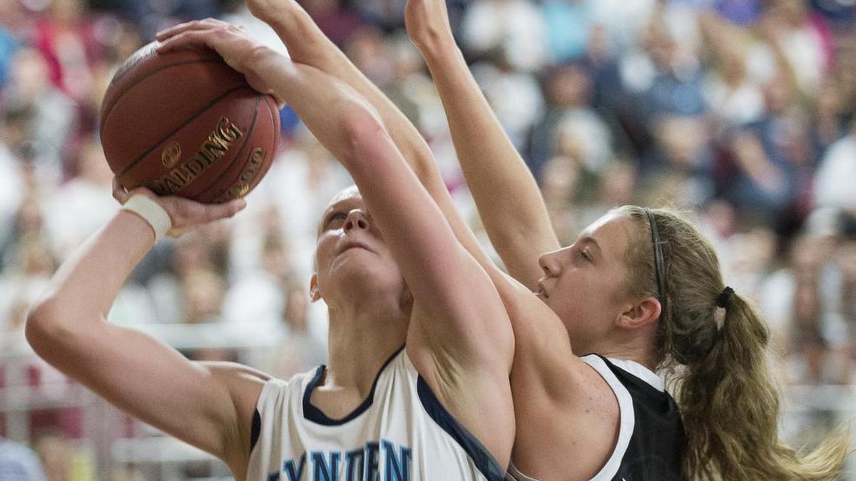 Lynden Christian’s Sam Van Loo, left, shoots and scores while being fouled by Meridian’s Jolee Sipma at the Class 1A Hardwood Classic on Friday, March 3, at the Yakima Valley SunDome in Yakima. Lynden Christian defeated Meridian 56-42 in overtime and will play Bellevue Christian for fourth place.