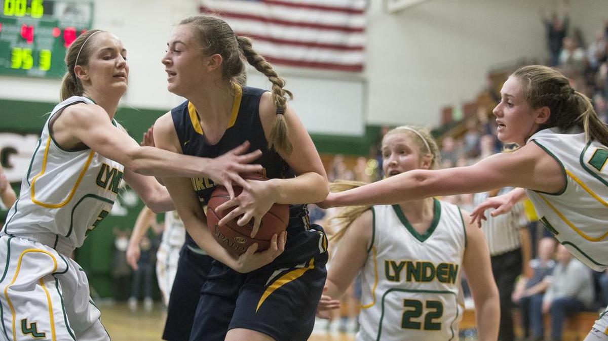 Lynden's Lauren Zwiers, left, Natalie Amos, right, and Elisa Kooiman attempt to foul Burlington-Edison's Katie King as the final second ticks off the clock on Saturday, Feb. 25, at Mount Vernon High School. Lynden lost 51-50.