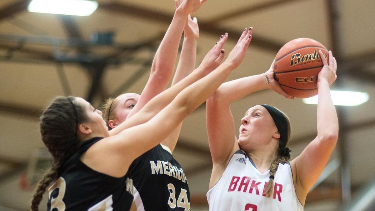 Mount Baker's Emily Brandland, right, shoots over Meridian's Mackenzie Cox, center, and Kyrin Baklund on Tuesday, Dec. 1, at Mount Baker High School in Deming.
