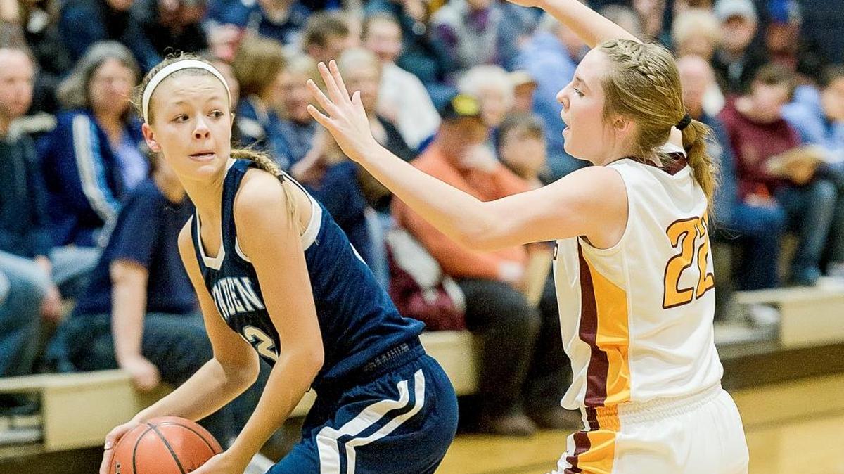 Lynden Christian's Avery Dykstra looks for an open team mate as White River's Georgia Lavinder (22) provides coverage during the second quarter of the Cloud 9 Sports Christmas Classic on Tuesday evening Dec. 29, at Lynden Christian High School.