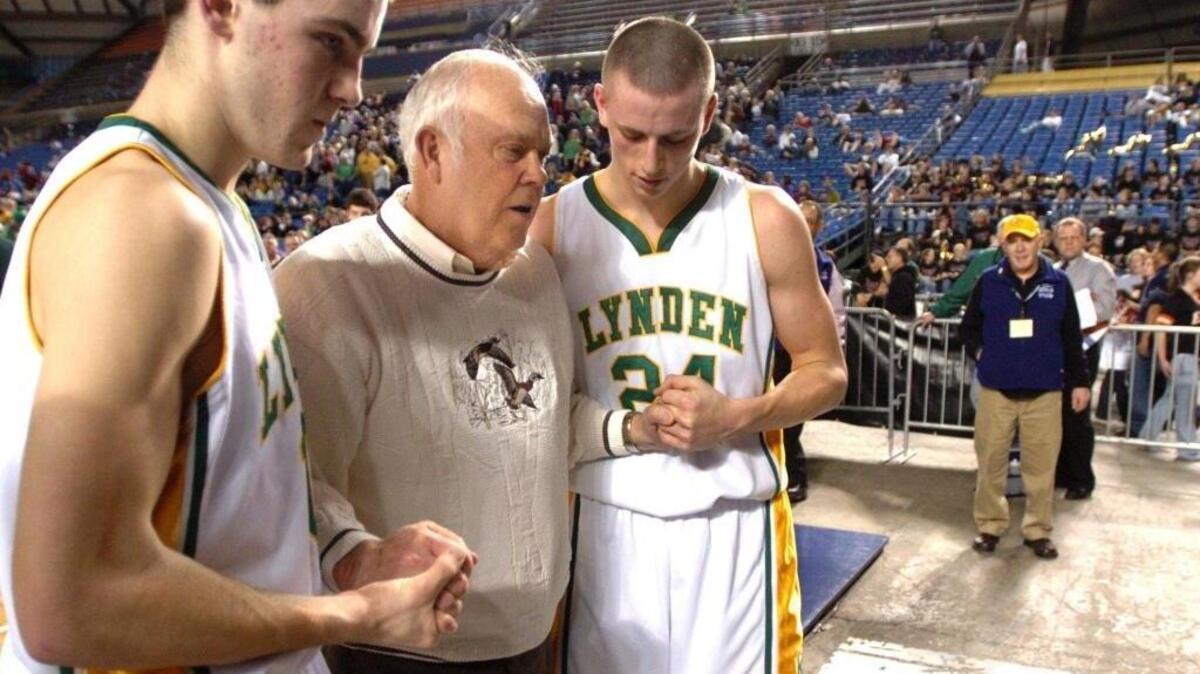 Lynden's Dirk Dallas, left, and Chris Bolt, right, walk with Jake Maberry during the Washington state basketball tournament at the Tacoma Dome on March 7, 2007. Maberry was being inducted into the WIAA Hall of Fame.