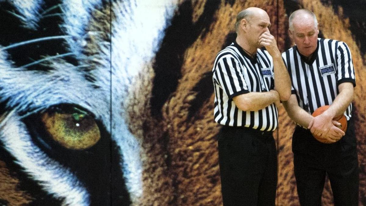Referees converse during a girls' basketball game between Lynden Christian and Burlington-Edison in 2015. The Northwest Board of Basketball Officials is seeking members to officiate high school and middle school boys and girls basketball games.
