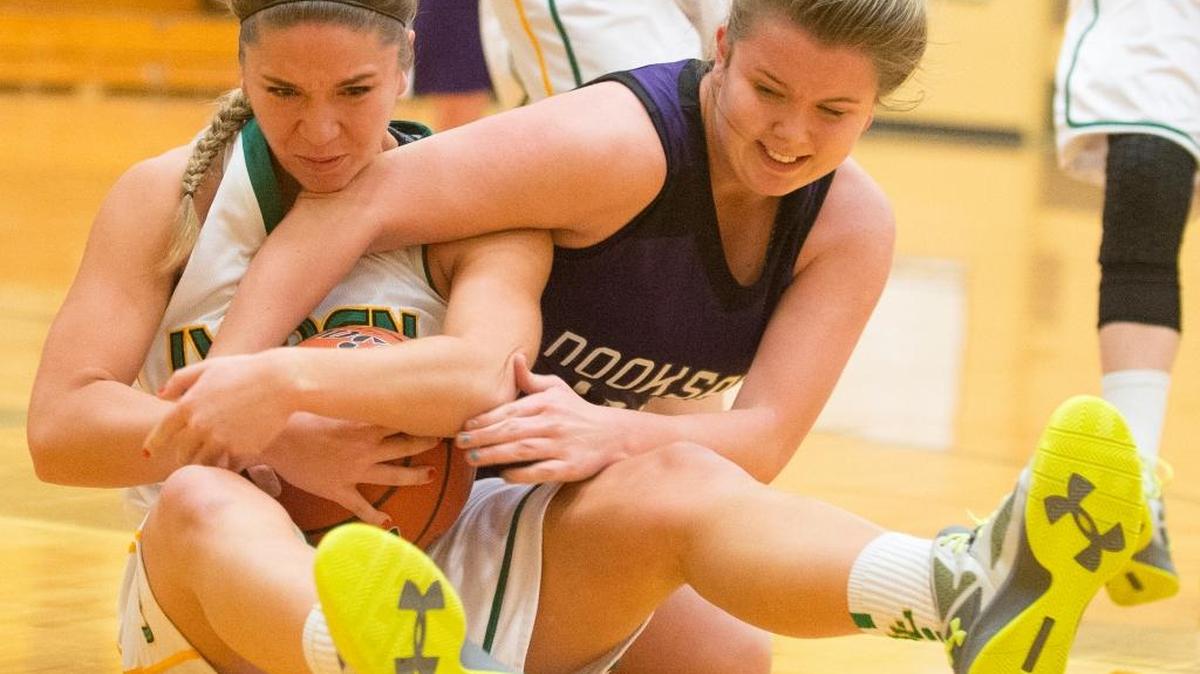 Lynden's Jasmyne Neria, left, and Nooksack Valley's Olivia Berkan wrestle for control of the ball on Tuesday, Dec. 15, at Lynden High School in Lynden.