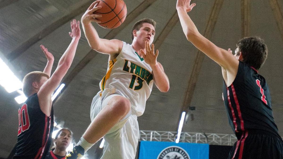 Lynden's Sterling Somers passes the ball while in midair during a loss to Clarkston a 2A boys' state semifinal game on Friday, March 4, at the Yakima Valley SunDome.