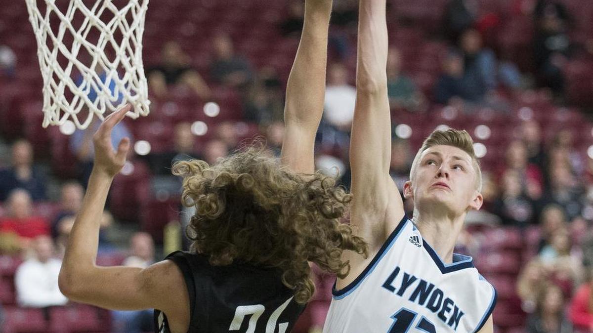 Lynden Christian's Cole Bajema blocks a shot by Newport's Adam Moorhead on day two of the Hardwood Classic on Thursday, March 2, at the Yakima Valley SunDome in Yakima. Lynden Christian defeated Newport 57-38.