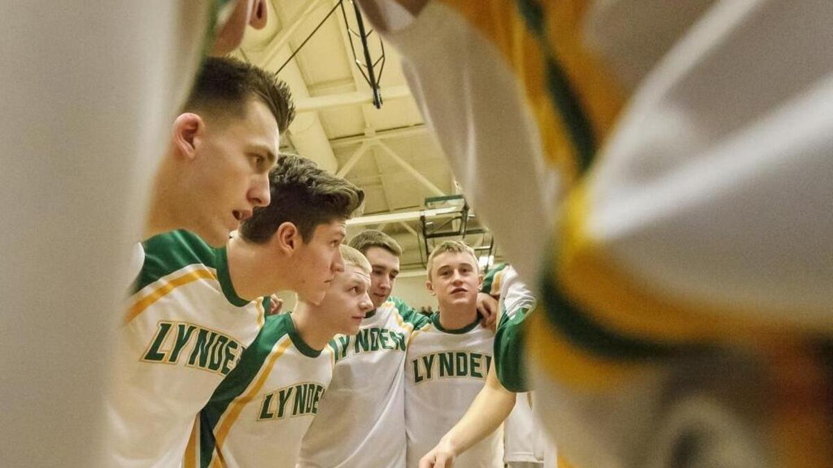 Lynden huddles before its game against Bellingham in a winner-to-state game in the Class 2A bi-district tournament Saturday at Mount Vernon High School. The Lions won and received the top seed into the 2A State Tournament.