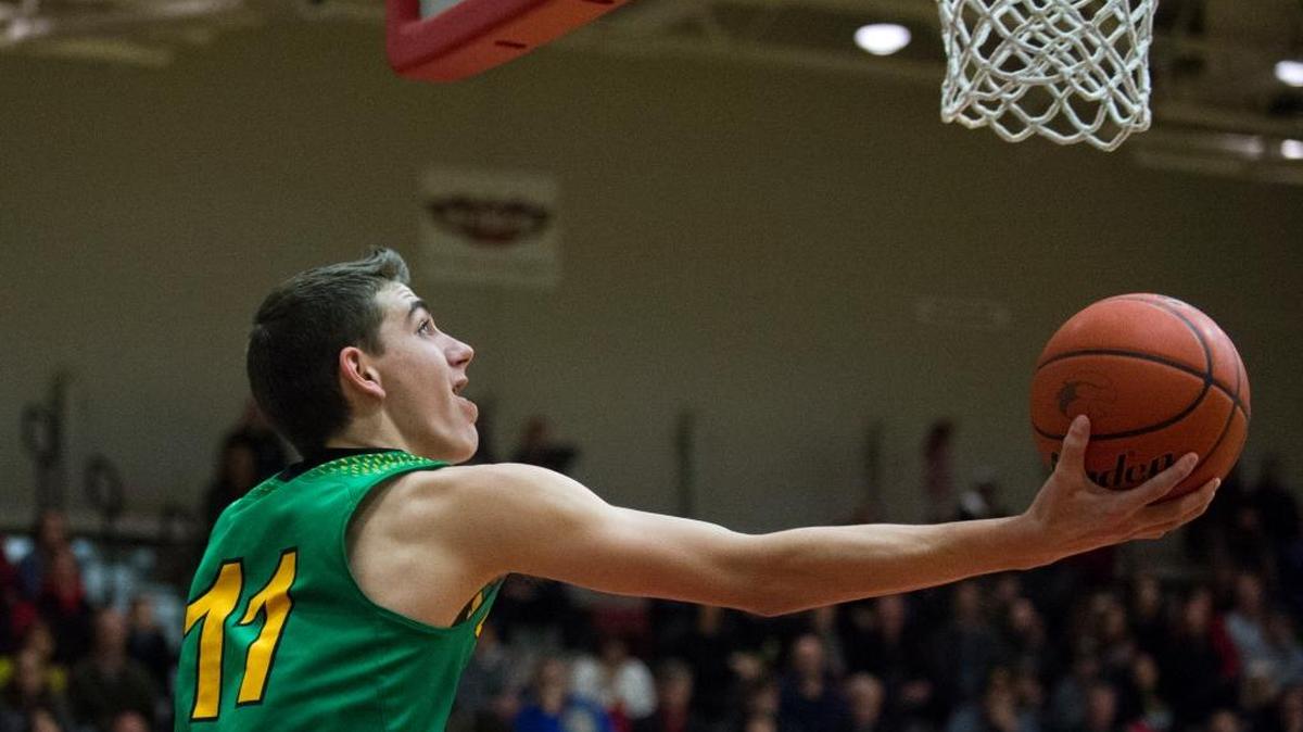 Lynden’s Clayton Whitman makes a layup from behind the hoop during a 71-66 victory over Bellingham on Friday, Feb. 3, at Bellingham High School.