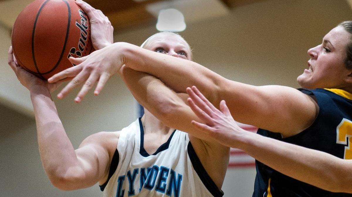 Lynden Christian’s Sam Van Loo, left, shoots and scores while being fouled by Burlington-Edison's Rylee Gundersen on Wednesday, Jan. 12, at Lynden Christian High School. Lynden Christian won 71-58.