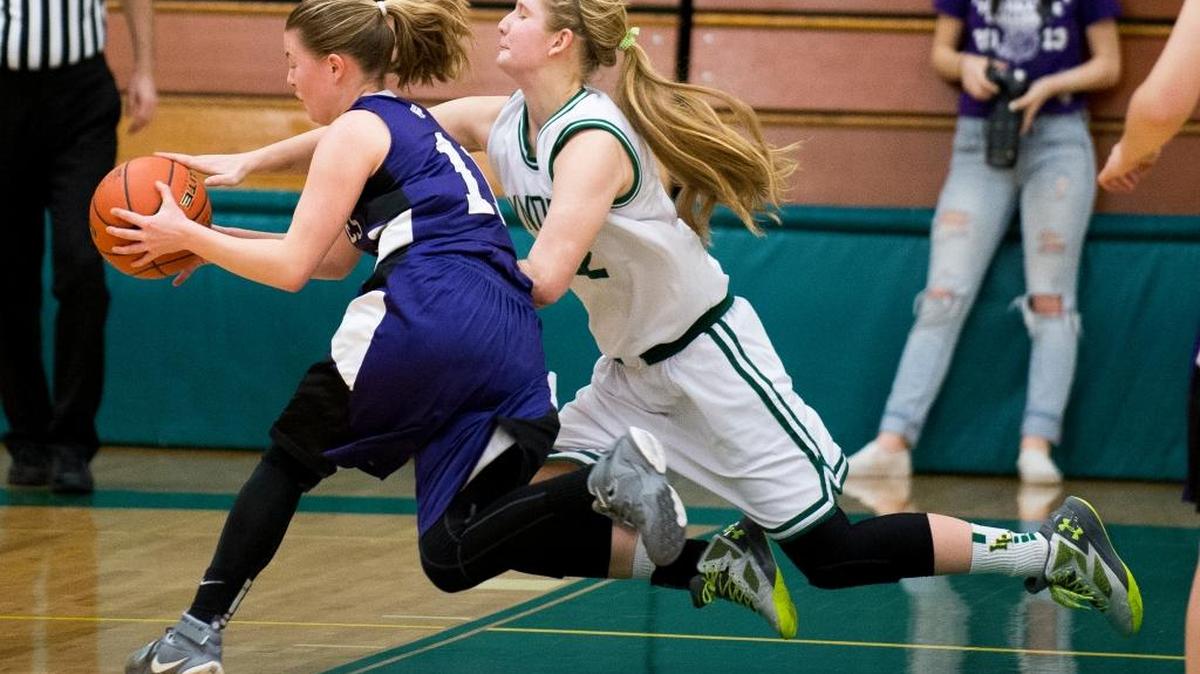 Lynden's Elisa Kooiman competes with Anacortes' Maddy Hance for a loose ball on Friday, Feb. 19, in Mount Vernon.