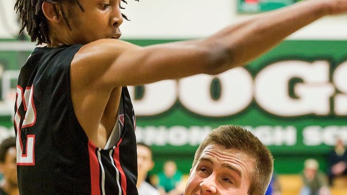 Archbishop Murphy’s Jaylon Carter (12) guards Lynden’s Sterling Somers (13) as he attempts a basket during the second quarter in the 2A District Boys Tournament on Saturday, Feb. 20, at Mount Vernon High School.