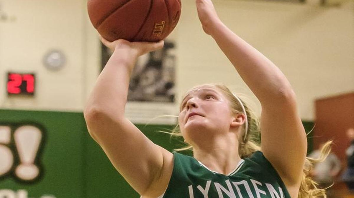 Lynden’s Elisa Kooiman (22) goes over Burlington-Edison’s Annaleis Reyes (24) during the third quarter in the Class 2A Northwest District Tournament semifinals Feb. 13 at Mount Vernon.