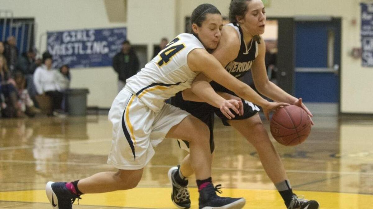 Burlington-Edison’s Annaleis Reyes, left, and Meridian's Kyrin Baklund race after a loose ball Feb. 2 in Burlington.