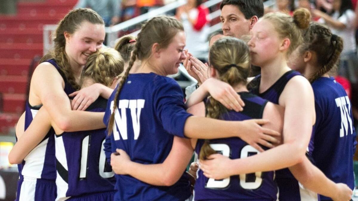 Nooksack Valley players embrace in a bittersweet moment after losing to Granger in the third-place game of the 1A girls' state basketball tournament at the Yakima Valley SunDome in Yakima.