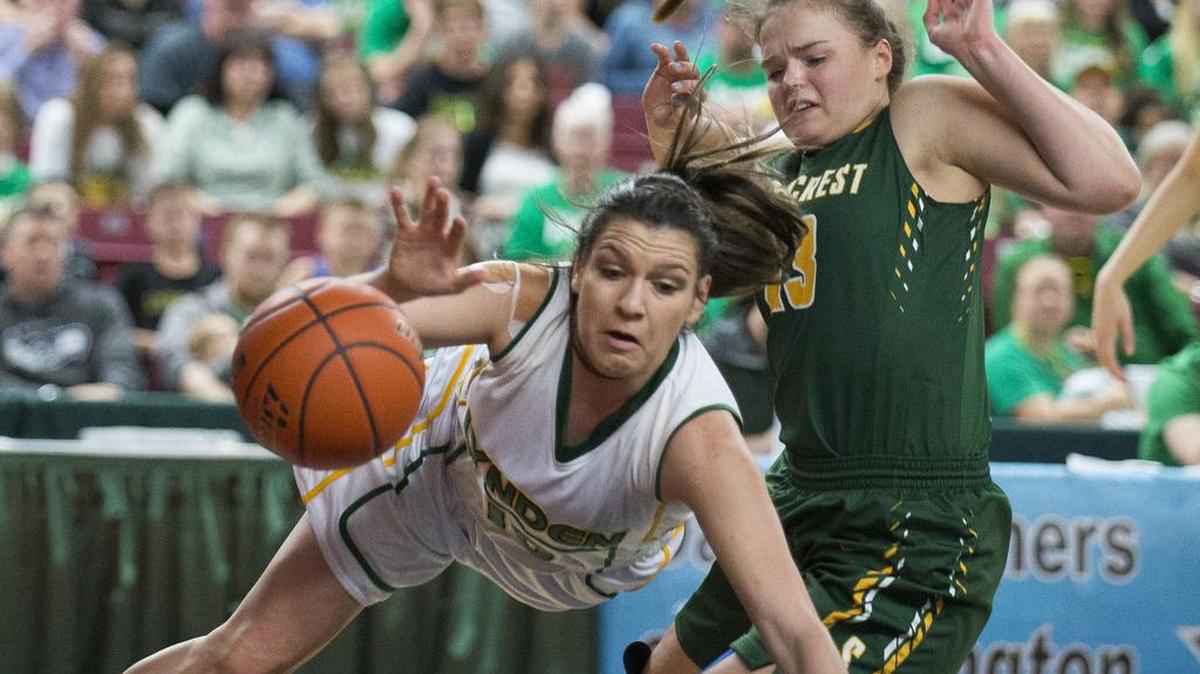 Lynden’s Mariah Gonzalez dives after the ball while being fouled by Shorecres’'s Sheridan Stephenson during the 2A girls state championship game on Saturday, March 5, at the Yakima Valley SunDome.