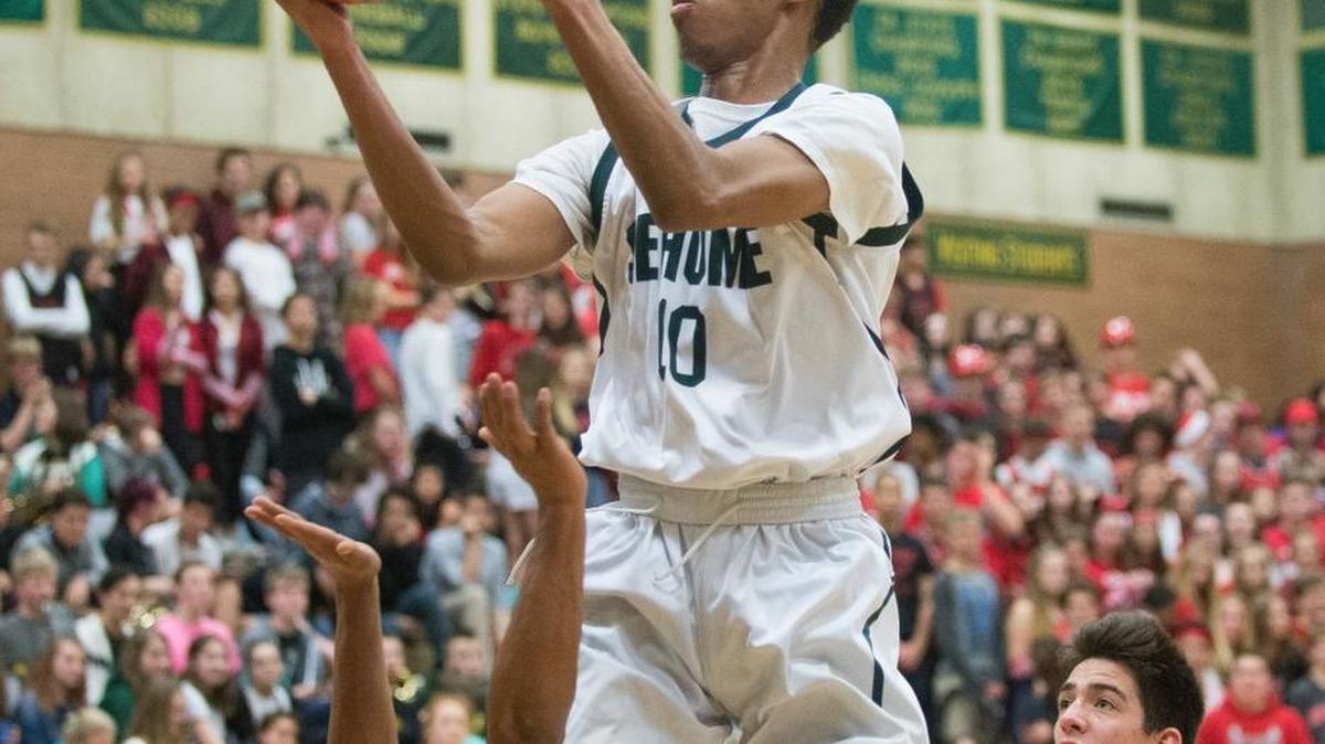 Sehome’s JaKobe Woodfork scores over Bellingham’s Spencer Lee on Friday at Sehome High School. Sehome won 66-65.