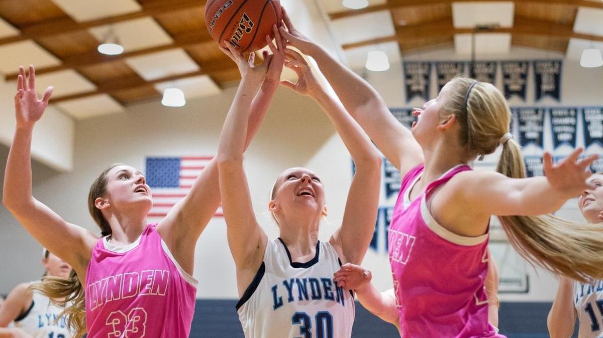 Lynden's Natalie Amos, left, and Elisa Kooiman, right, block a shot by Lynden Christian's Riley Van Hulzen on Friday, Jan. 22, at Lynden Christian High School. Lynden won 55-45.