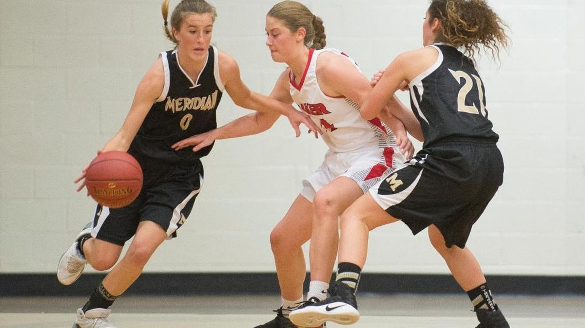 Meridian’s Madeline Bowler, left, dribbles past Mount Baker’s McKenzie Yost, center, with the help of a screen from Natalie Swanson on Thursday, Nov. 30, at Mount Baker High School in Deming. Meridian defeated Mount Baker 62-56.
