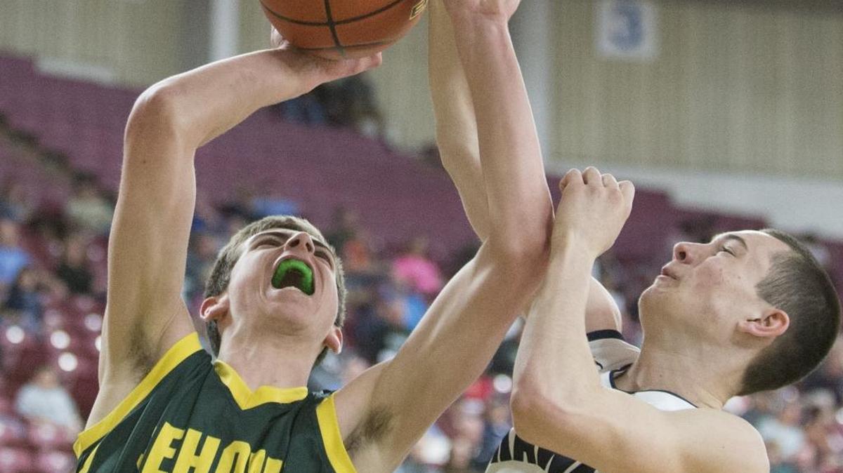 Sehome’s Leighton Kingma is fouled by River Ridge’s Mac Armstrong in a 2015 Class 2A State Tournament quarterfinal at the Yakima Valley SunDome.