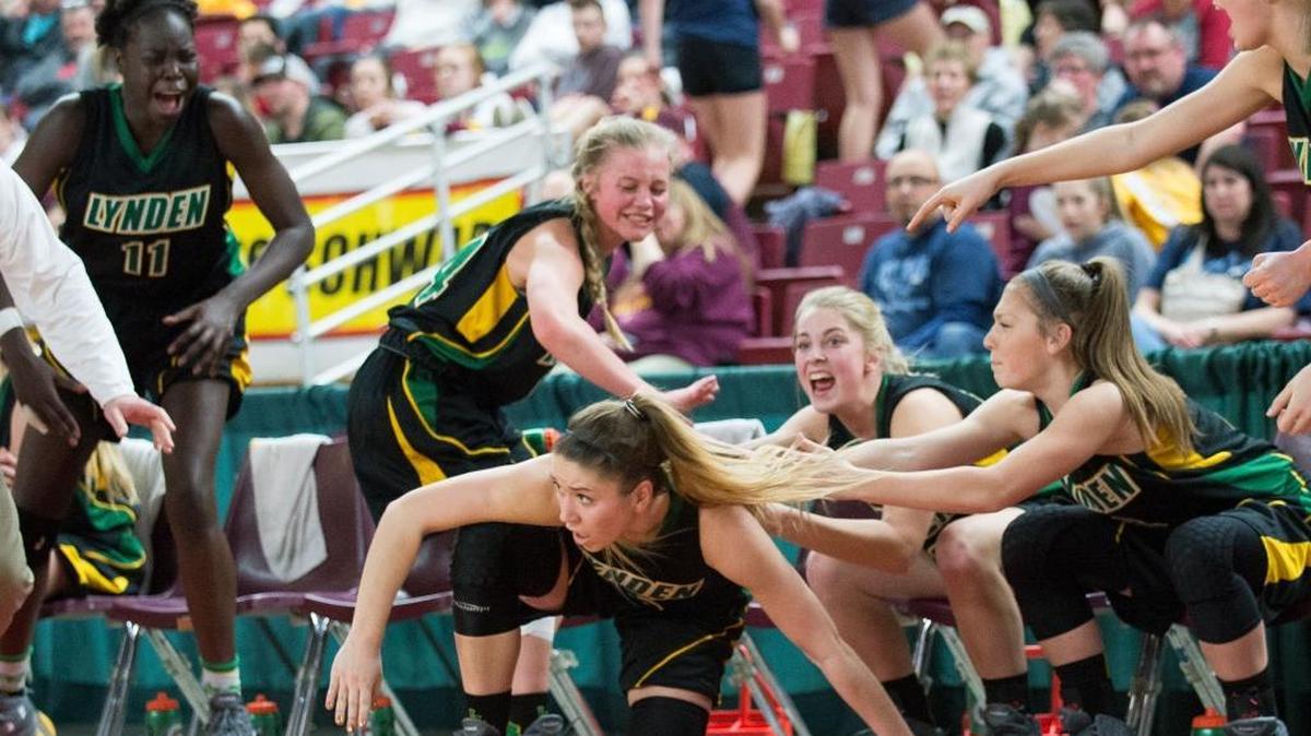 Lynden players celebrate after Jasmyne Neria, center, made a three-point basket as the shot clock expired while falling into the bench during a 64-42 victory over White River in the Class 2A Hardwood Classic on Thursday, March 2, at the Yakima Valley SunDome in Yakima.