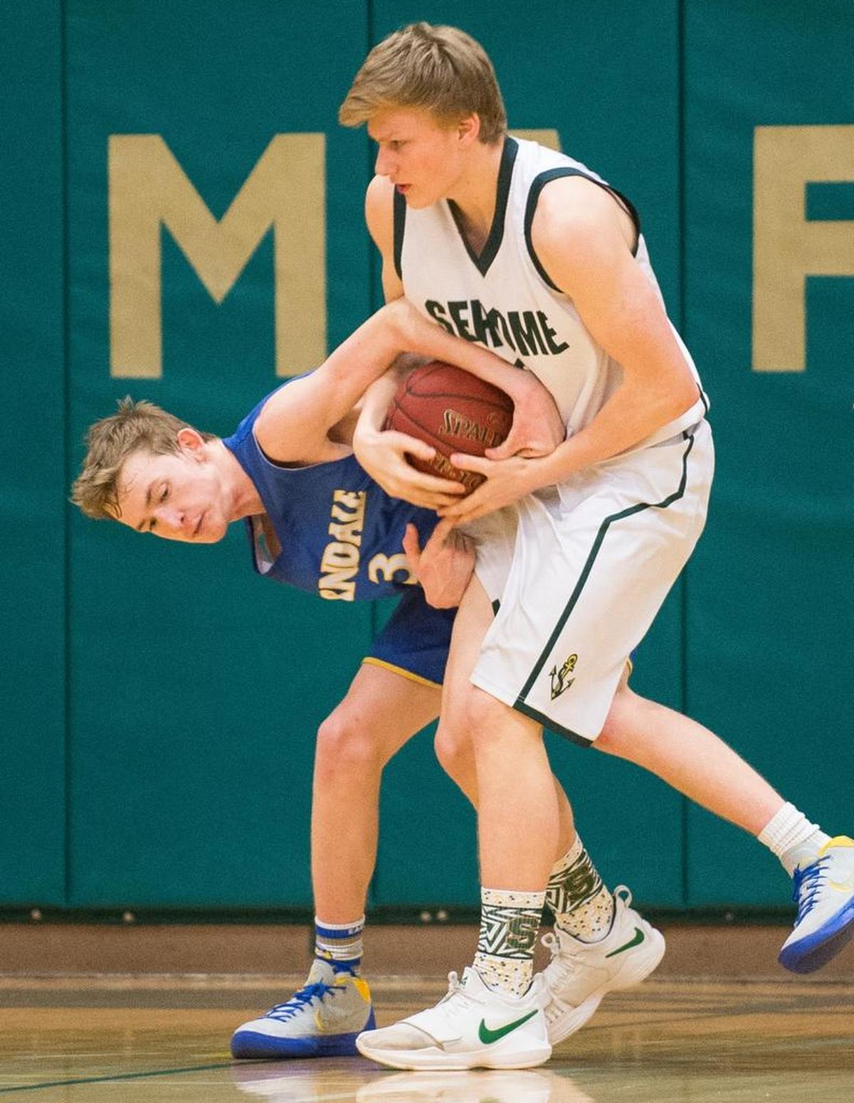 Ferndale;s AJ Rankin, left, and Sehome’s Andrew Engle battle for control of the ball on Wednesday at Sehome. Ferndale won 74-61.