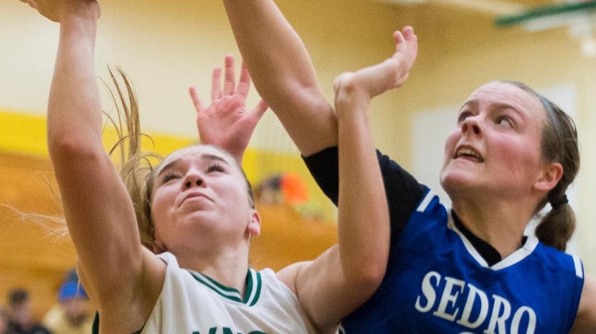 Lynden's Jasmyne Neria is fouled while shooting by Sedro-Woolley's Kate Morgan on Friday, Feb. 12, at Lynden High School.