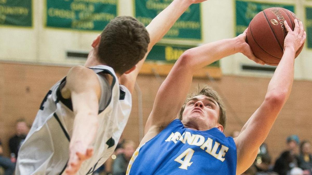 Ferndale’s Cody Gunter, right, shoots around the arm of Sehome’s Eddy Hochsprung on Wednesday at Sehome. Ferndale won 74-61.