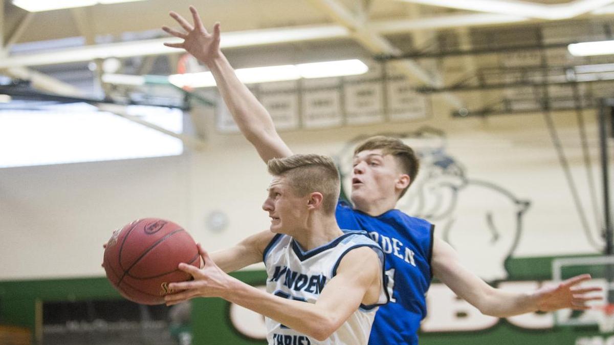 Lynden Christian's Cole Bajema drives to the hoop past Warden's Adam Richins Lynden on Saturday, Feb. 25, at Mount Vernon High School. Lynden Christian won 61-55.