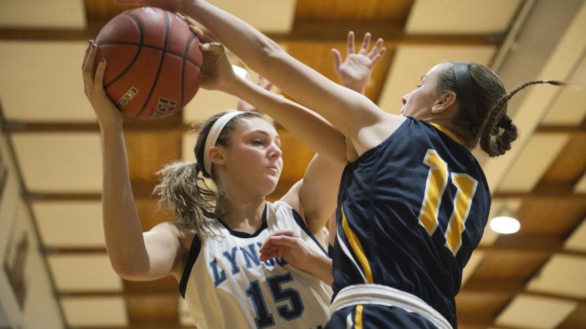 Lynden Christian’s Kara Bajema looks for an opening around Burlington-Edison’s Edie Breckenridge during a game on Tuesday, Jan. 12.