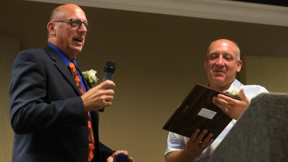Lynden Christian’s Roger DeBoer, right, is presented with a ring and a plaque by WIBCA President Pat Fitterer at the Hall of Fame induction ceremony Thursday, July 28, in Ferndale. DeBoer was inducted into the WIBCA Hall of Fame along with Squalicum’s Dave Dickson and Lynden’s Brian Roper.