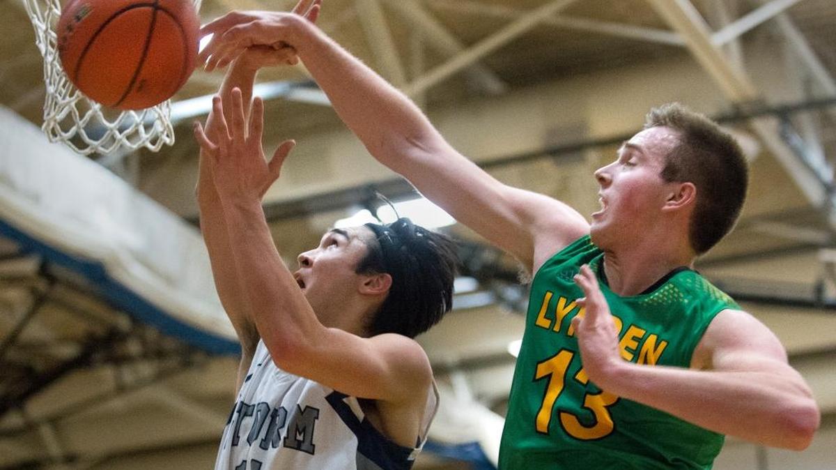 Lynden’s Sterling Somers blocks a shot by Squalicum’s Josh Vail on Tuesday, Feb. 9, at Squalicum High School. Lynden won the game 73-70 to tie with Lynden Christian for a share of the Northwest Conference title.