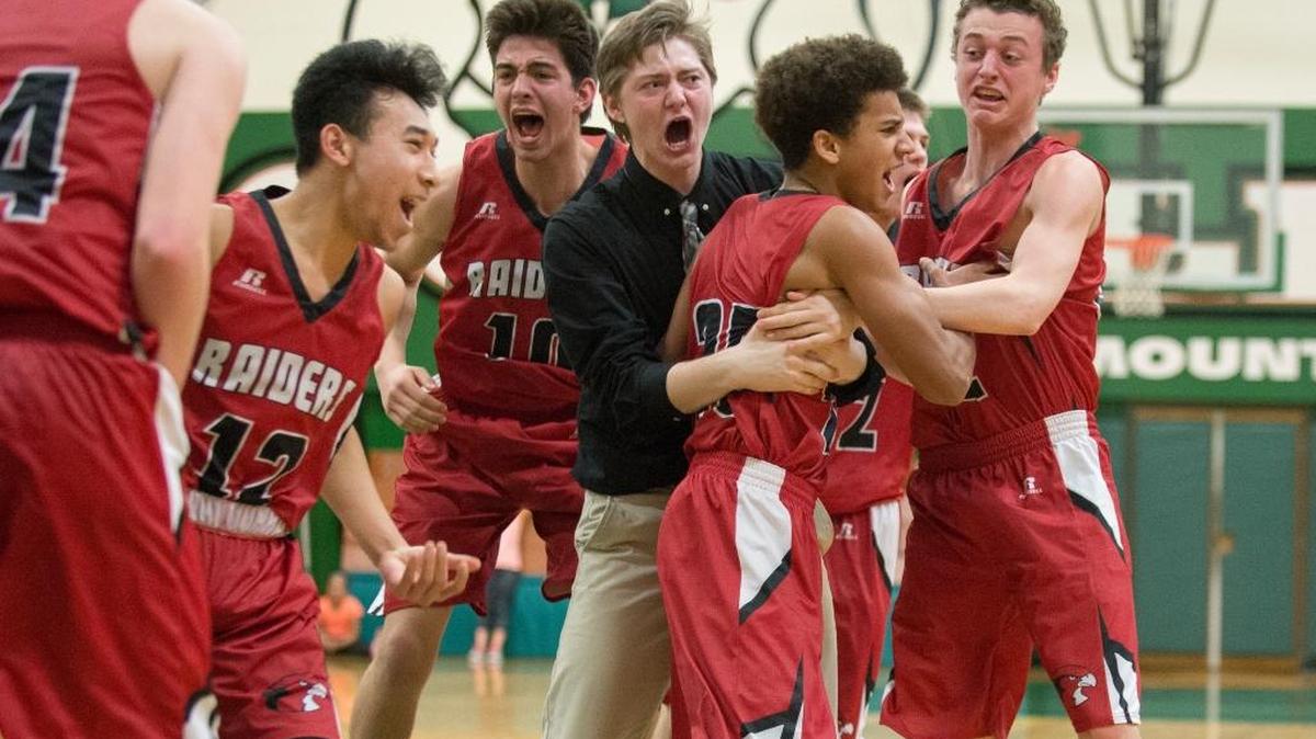 Bellingham players rush the court to celebrate after Spencer Lee, center right, made the game-winning shot to defeat Archbishop Murphy, 80-78, in a Class 2A Northwest District loser-out game on Thursday, Feb. 16, at Mount Vernon High School.