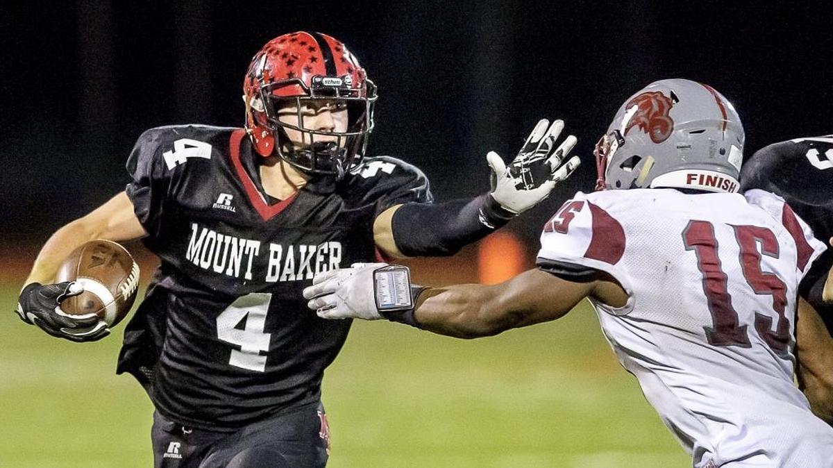 Mount Baker’s Jed Schleimer (4) stiff arms Hoquiam’s Artimus Johnson during a Class 1A state playoff game on Nov. 12, 2016, at Civic Stadium in Bellingham. Schleimer has been selected to play in the East-West All-Star Game on June 24 in Yakima.