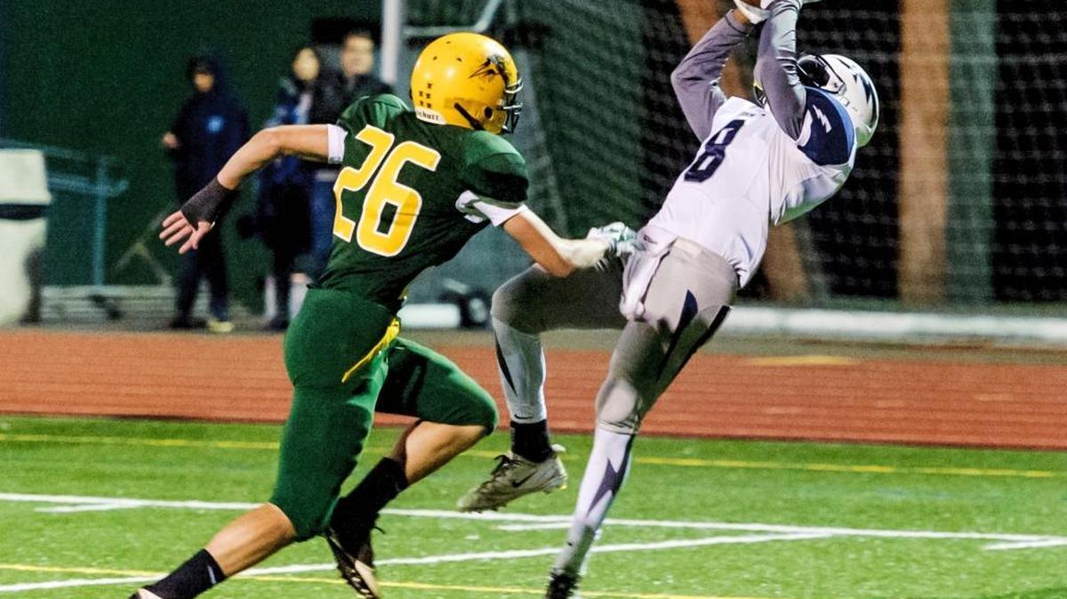 
Squalicum running back Damek Mitchell pulls in a pass for a touchdown as Sehome outside linebacker Nathan Carroll moves in during the first quarter Friday, Oct. 16, at Civic Stadium.
