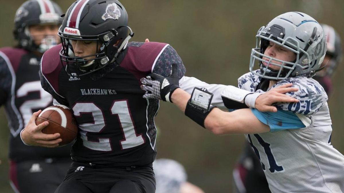 Lummi’s Caleb Revey tries to break free from a Rainier Christian defender during a 58-16 victory in the Class 1B quad-district playoffs Nov. 11. The Blackhawks will face Tacoma Baptist Saturday at Sammamish High School.