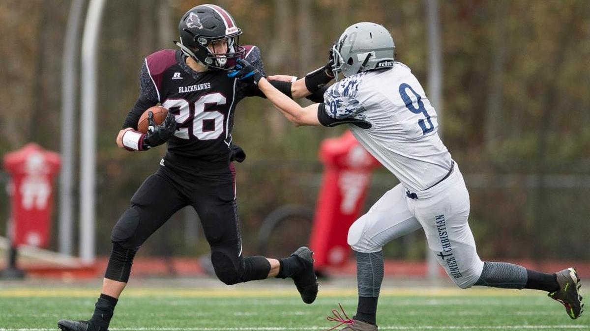 Lummi’s Justin Mahle tries to avoid a Rainier Christian defender during a Nov. 11 Class 1B qua-district playoff game at Lummi Nation School.