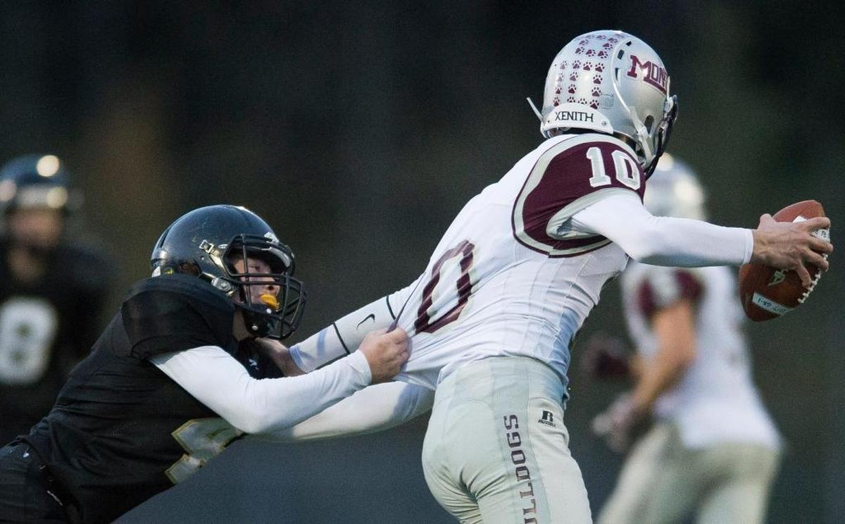 Meridian’s Jake Cheney tries to wrap up Montesano’s Trevor Ridgway in the Class 1A state quarterfinals on Saturday, Nov. 18, at Civic Stadium in Bellingham.