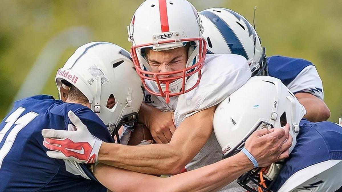 Squalicum defenders wrap up Bellingham wide receiver Cole Allain as he attempts to return a kick on Sept. 4