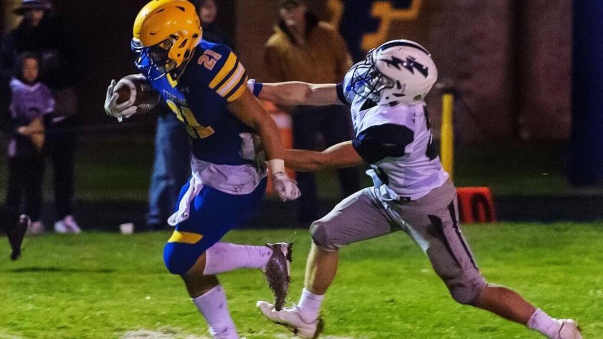 Ferndale running back Cole Semu scores a touchdown, as Squalicum defensive back Triston Smith makes a last-ditch effort to stop him during the second quarter on Friday.
