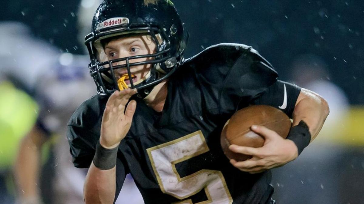 Meridian’s Cole Roberts runs toward an opening Oct. 21 against Nooksack Valley. The Trojans host Connell in the Class 1A state quarterfinals Saturday at Civic Stadium.