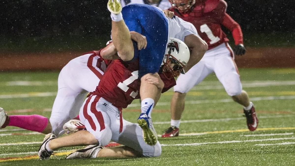 
Bellingham’s Noah Hadfield lifts LaConner’s Seth Schuh over his head while making a tackle Saturday, Oct. 25, at Civic Stadium in Bellingham.
