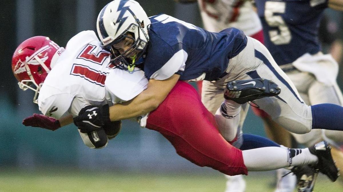 Squalicum’s Ashton Dial tackles Marysville-Pilchuck’s Jacob Carr Sept. 16 at Civic Stadium in Bellingham.