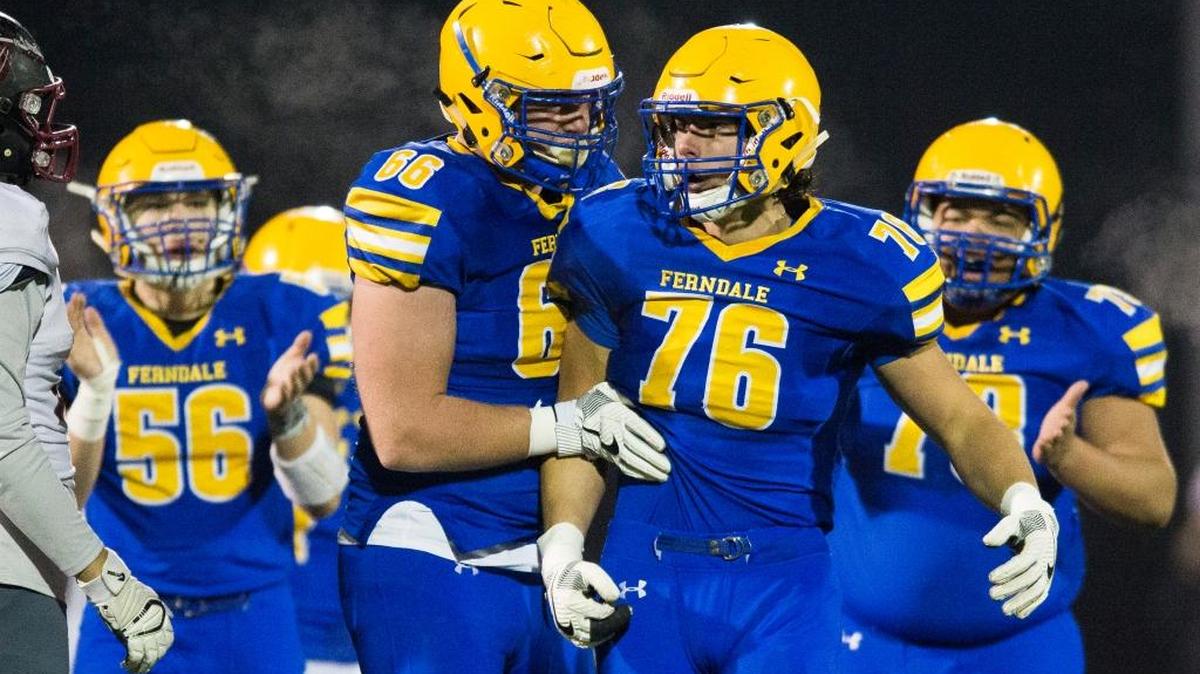 Ferndale’s Mikhail Varetskiy, right, and Geirean Hatchett, left, celebrate stopping a Bethels running back for a loss in the first round of Class 3A state playoffs on Friday, Nov. 10, at Civic Stadium in Bellingham.