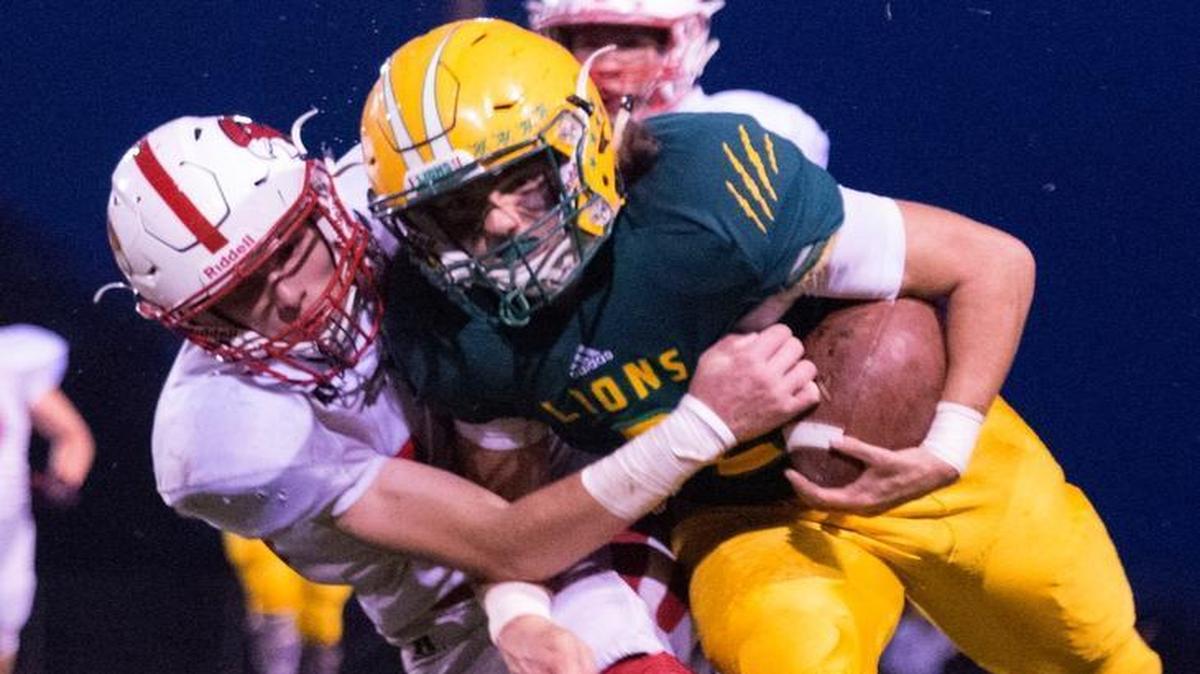 Lynden quarterback Jacob Hommes fights through a tackle in a Sept. 16 game against Bellingham.