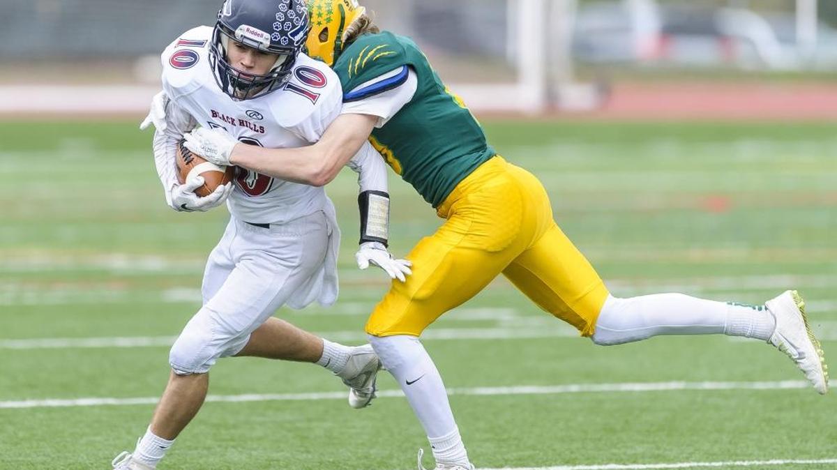 Black Hills’ Nate Kindell gets stopped by Lynden’s Connor Shine during the Lions’ Class 2A state playoff first round victory Nov. 12 at Civic Stadium.