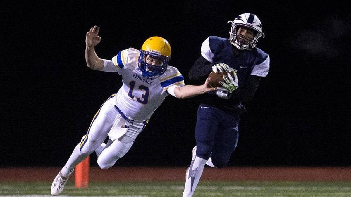 Squalicum’s Damek Mitchel, right, hauls in a pass in front of Ferndale’s James Hinson Saturday, Oct. 22, at Civic Stadium.