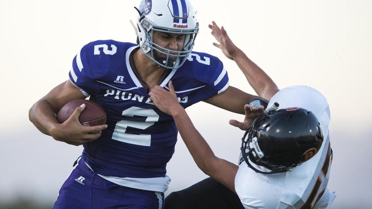 Nooksack Valley’s Casey Bauman, left, stiff-arms Blaine’s Mason Vega during a Sept. 1 game. The Pioneers travel to Sumner Saturday to face Cascade Christian in the first round of the Class 1A State Playoffs.
