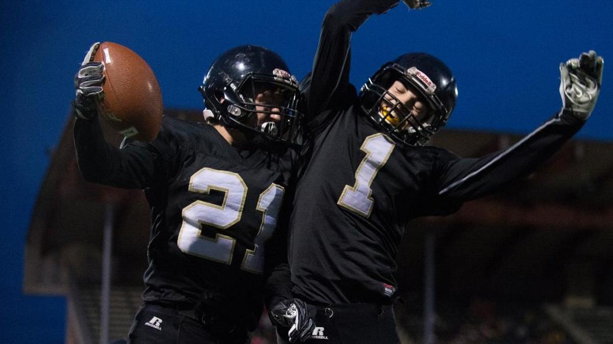 Meridian’s Lukas Hemenway, left, celebrates an interception with teammate Dawson Logan in the fourth quarter of a 28-7 victory over Montesano in the Class 1A state quarterfinals Saturday, Nov. 18, at Civic Stadium in Bellingham.